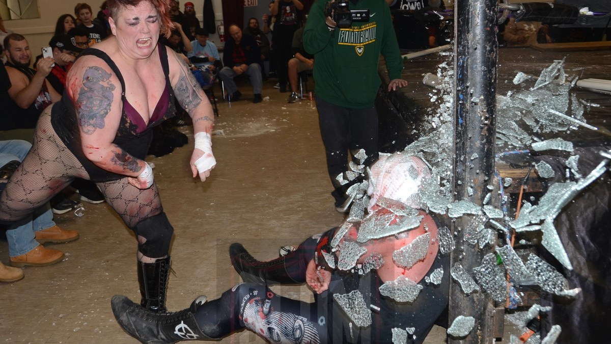 Mickie Knuckles breaks glass over JJ Escobar during a match on January 5, 2024. Photo by Brad McFarlin